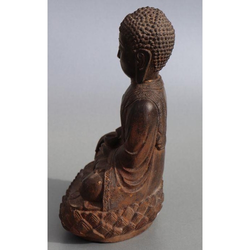 685 - A Chinese cast figure depicting a seated Buddha on a lotus flower pedestal, 33cms high.Condition Rep... 