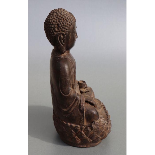 685 - A Chinese cast figure depicting a seated Buddha on a lotus flower pedestal, 33cms high.Condition Rep... 