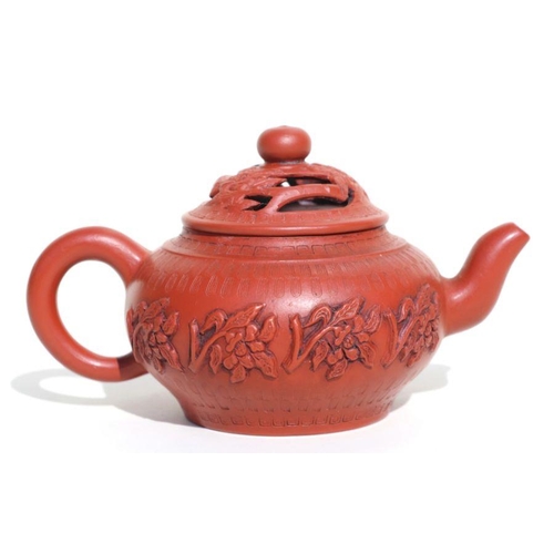 687 - A Chinese Yixing pottery teapot decorated with flowers, impressed seal mark to the underside, 8cms h... 