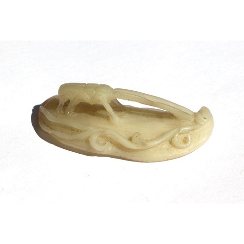 688 - A Chinese jade carving in the form of a longhorn beetle on a peapod, 6cms long; together with a jade... 