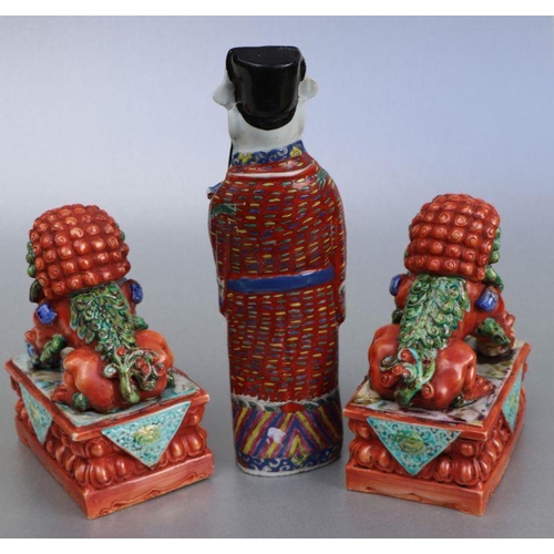 689 - A pair of Chinese orange glaze temple lions on plinths, 20cms high; together with a figure of a robe... 