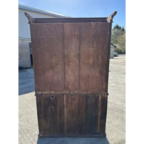 703 - A Victorian bookcase on cupboard, the pair of glazed doors enclosing a shelved interior with cupboar... 