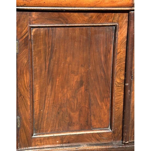 703 - A Victorian bookcase on cupboard, the pair of glazed doors enclosing a shelved interior with cupboar... 