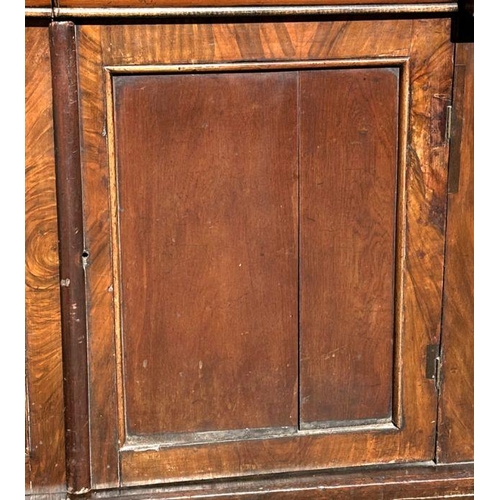 703 - A Victorian bookcase on cupboard, the pair of glazed doors enclosing a shelved interior with cupboar... 