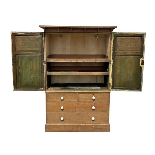 757 - A pine linen press, the upper section with a moulded cornice above two panelled doors enclosing a sh... 