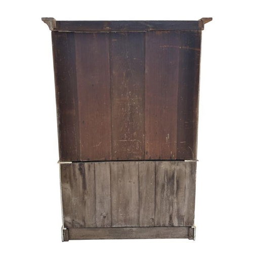 757 - A pine linen press, the upper section with a moulded cornice above two panelled doors enclosing a sh... 