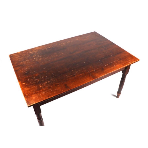 761 - A stained pine kitchen table with single end drawer, on ring turned legs, 132cms wide.