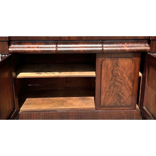 762 - A 19th century flame mahogany sideboard or chiffonier with three frieze drawers above panelled doors... 