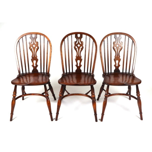 771 - A set of six oak wheelback dining chairs with crinoline stretchers; together with an oak oval extend... 