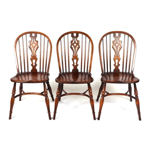 771 - A set of six oak wheelback dining chairs with crinoline stretchers; together with an oak oval extend... 