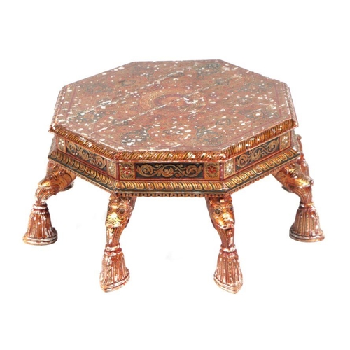 774 - A Kashmiri low prayer table, the octagonal top on eight hoof support legs, 67cms wide.