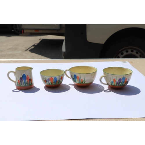 252 - A Clarice Cliff Bizarre Crocus pattern tea set, nine pieces to include teapot.