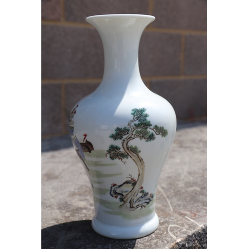 581 - A Chinese baluster vase decorated with figures in a landscape, six character mark to base, 25cms hig... 