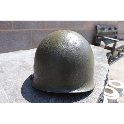 94 - A quantity of assorted militaria to include a USA steel helmet; a collapsible field shovel; goggles;... 