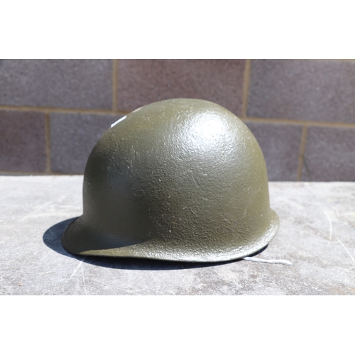 94 - A quantity of assorted militaria to include a USA steel helmet; a collapsible field shovel; goggles;... 