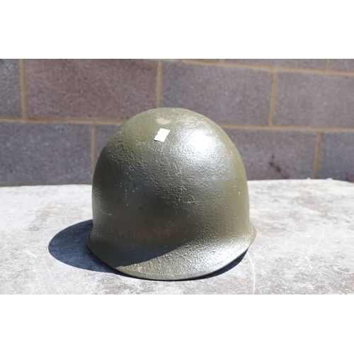 94 - A quantity of assorted militaria to include a USA steel helmet; a collapsible field shovel; goggles;... 