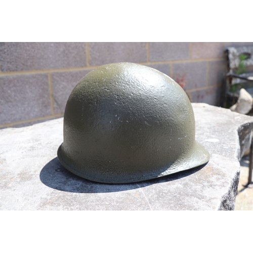 94 - A quantity of assorted militaria to include a USA steel helmet; a collapsible field shovel; goggles;... 