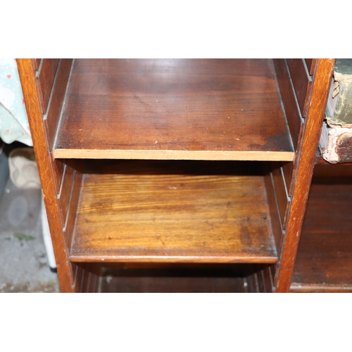 764 - An early 20th century oak open bookcase with an arrangement of adjustable shelves, on bracket feet, ... 