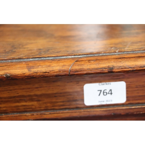 764 - An early 20th century oak open bookcase with an arrangement of adjustable shelves, on bracket feet, ... 