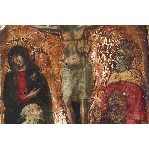 366 - A painted wooden icon depicting the crucifixion of Christ, on a gilt ground, 18 by 29cms.