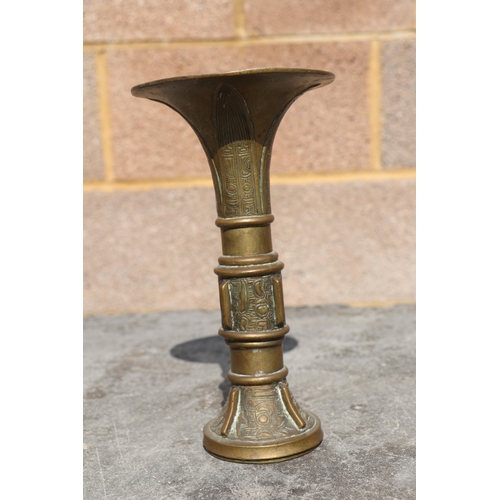 691 - A Chinese bronze / brass Gu type vase of archaic form, 21cms high.