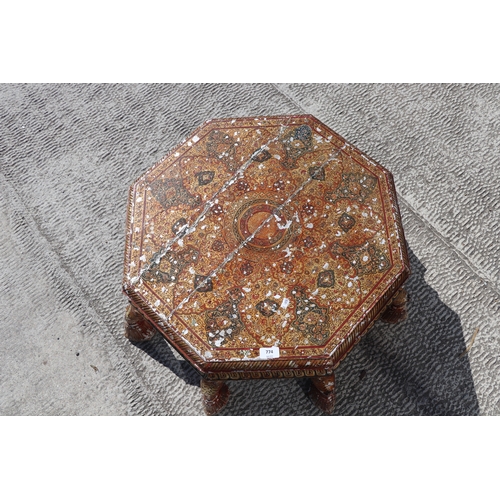 774 - A Kashmiri low prayer table, the octagonal top on eight hoof support legs, 67cms wide.