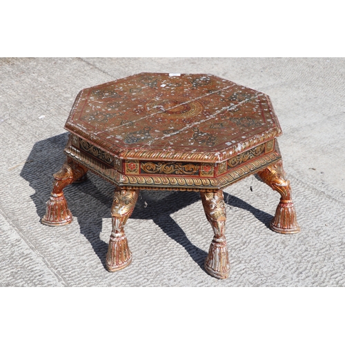 774 - A Kashmiri low prayer table, the octagonal top on eight hoof support legs, 67cms wide.