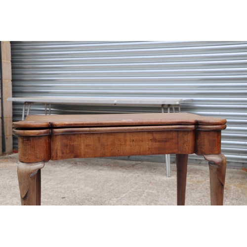 749 - A George III mahogany card table on turned legs terminating in pad feet, 84cms wide.