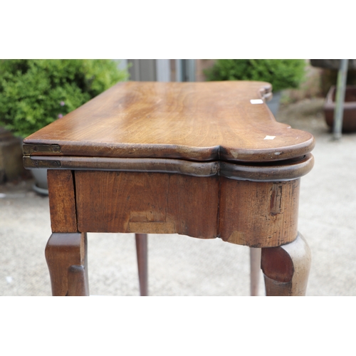 749 - A George III mahogany card table on turned legs terminating in pad feet, 84cms wide.