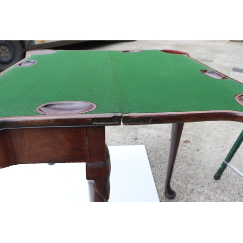 749 - A George III mahogany card table on turned legs terminating in pad feet, 84cms wide.