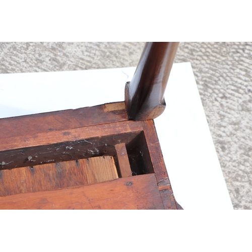 749 - A George III mahogany card table on turned legs terminating in pad feet, 84cms wide.