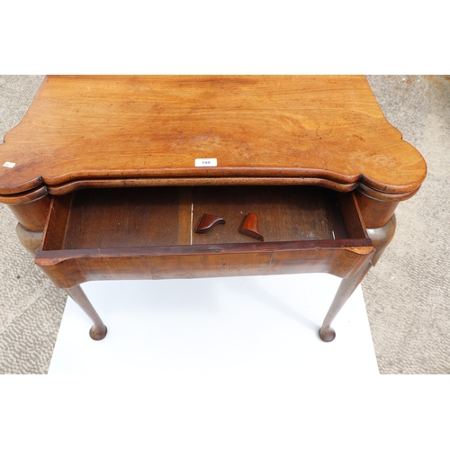 749 - A George III mahogany card table on turned legs terminating in pad feet, 84cms wide.