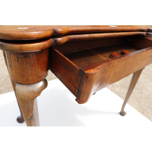 749 - A George III mahogany card table on turned legs terminating in pad feet, 84cms wide.