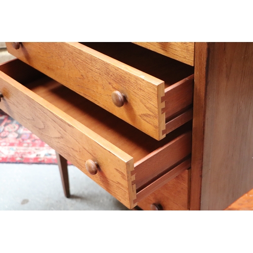 753 - A mid 20th century teak chest in the manner of Heal's with an arrangement of five long drawers, on t... 