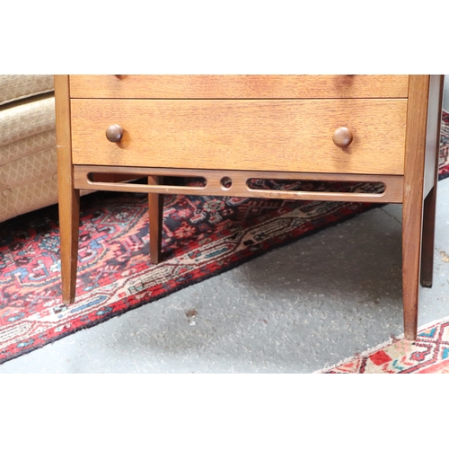 753 - A mid 20th century teak chest in the manner of Heal's with an arrangement of five long drawers, on t... 