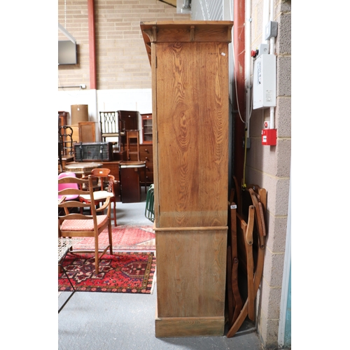 757 - A pine linen press, the upper section with a moulded cornice above two panelled doors enclosing a sh... 