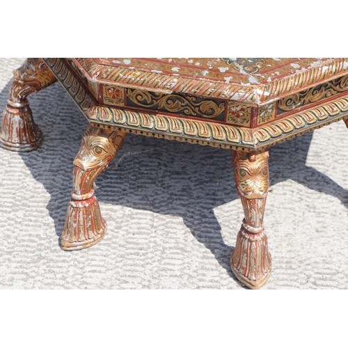 774 - A Kashmiri low prayer table, the octagonal top on eight hoof support legs, 67cms wide.