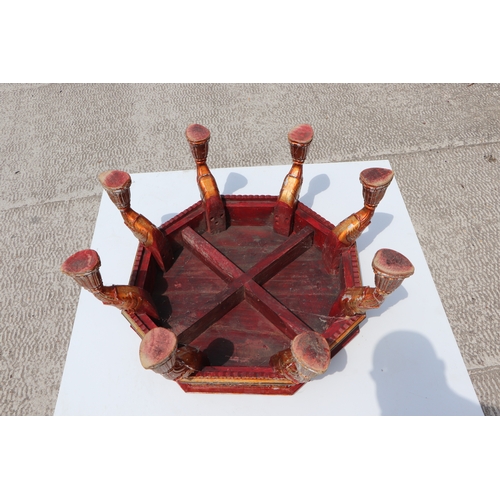 774 - A Kashmiri low prayer table, the octagonal top on eight hoof support legs, 67cms wide.