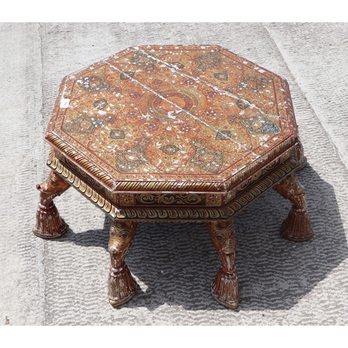 774 - A Kashmiri low prayer table, the octagonal top on eight hoof support legs, 67cms wide.