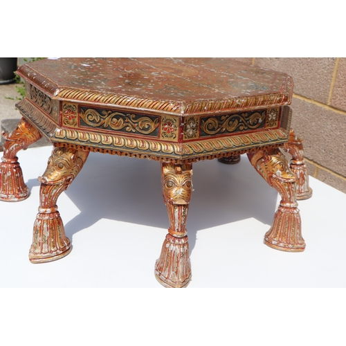 774 - A Kashmiri low prayer table, the octagonal top on eight hoof support legs, 67cms wide.