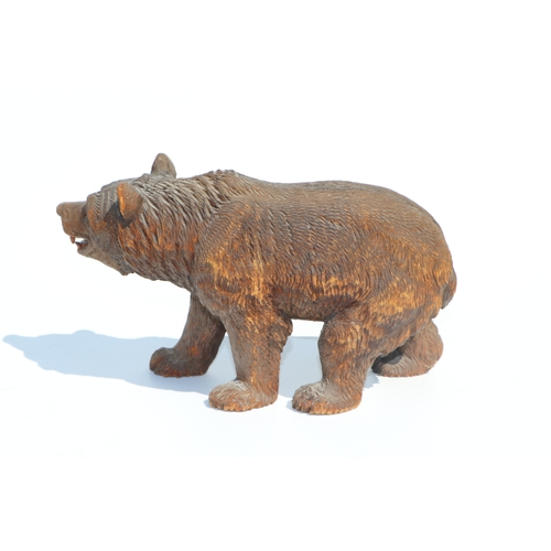 398 - A large Black Forest type carved figure of a walking bear, 28cms long; together with another similar... 