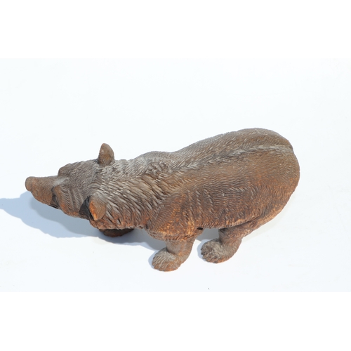 398 - A large Black Forest type carved figure of a walking bear, 28cms long; together with another similar... 