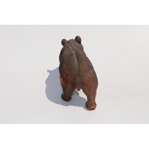 398 - A large Black Forest type carved figure of a walking bear, 28cms long; together with another similar... 