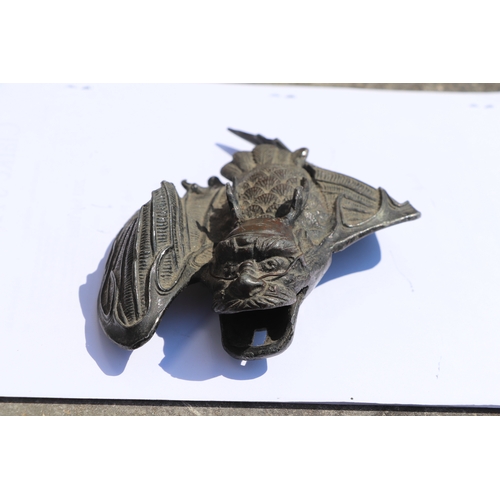 607 - A late 19th century Japanese bronzed wall pocket in the form of a stylised bat, 15cms high; together... 