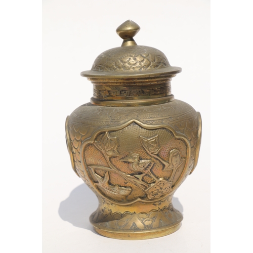 693 - A Chinese polished bronze / brass two-handled censer with six character mark to the underside, 11cms... 