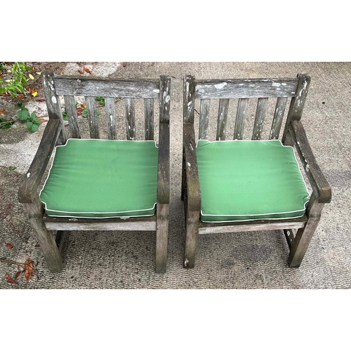 2 - A set of six well weathered  Iroko wood garden armchairs with slatted backs and seats; and a large m... 