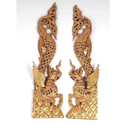 832 - A pair of Burmese carved giltwood and mirror jewelled temple wall hangings, 100cm high (2).