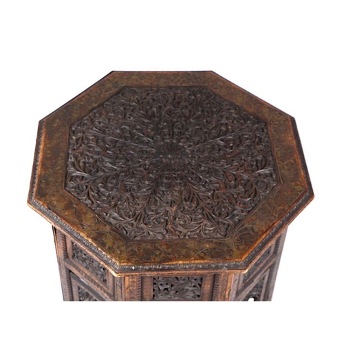 1013 - A Moroccan Moorish octagonal occasional table with brass inlaid decoration, 59cm wide.