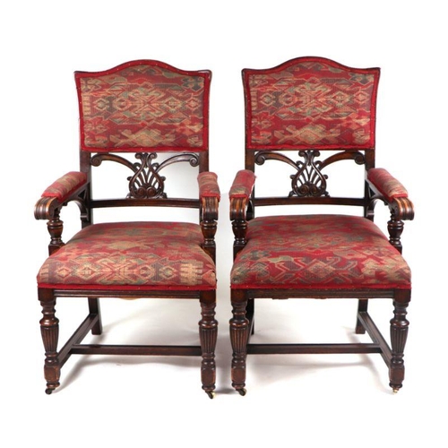 1018 - A pair of  Victoruan carver chairs with upholstered and carved backs, overstuffed seats, upholstered... 