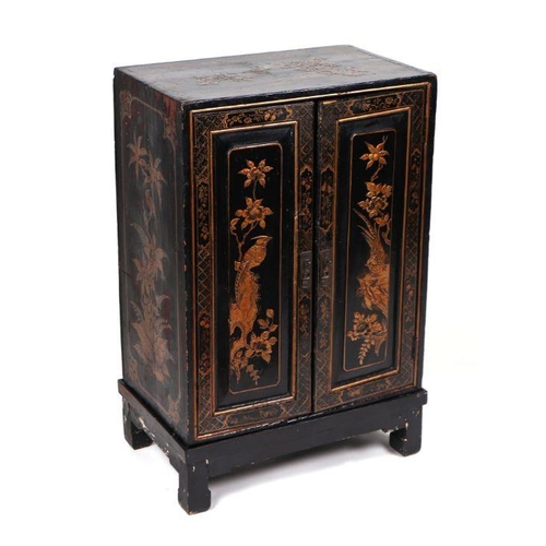 1023 - A chinoiserie two-door side cabinet decorated with birds and foliage, 54cm wide.